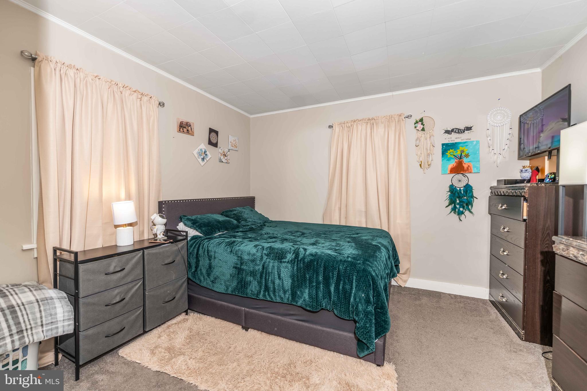5527 Locust Street Harrisburg, PA 17112 - Photo 10 of 14 a bedroom with a bed and a window