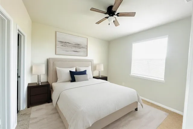 a bedroom with a large bed and a window