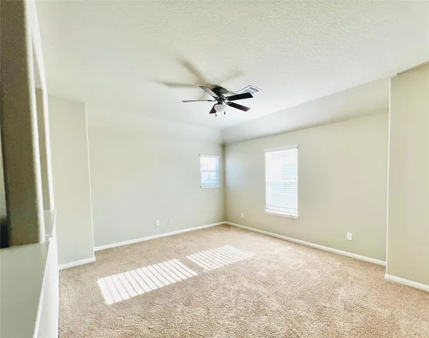 a view of room with a ceiling fan
