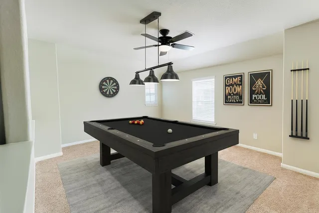 a room with table and wall paintings