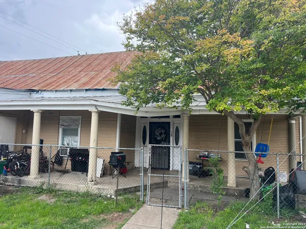 a view of a house with backyard porch and sitting area
