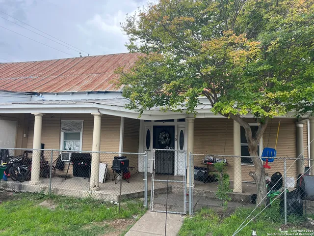 a view of a house with backyard porch and sitting area