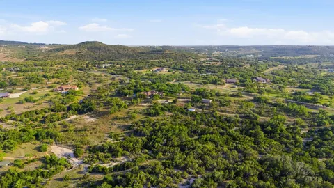 a view of a city with lush green forest