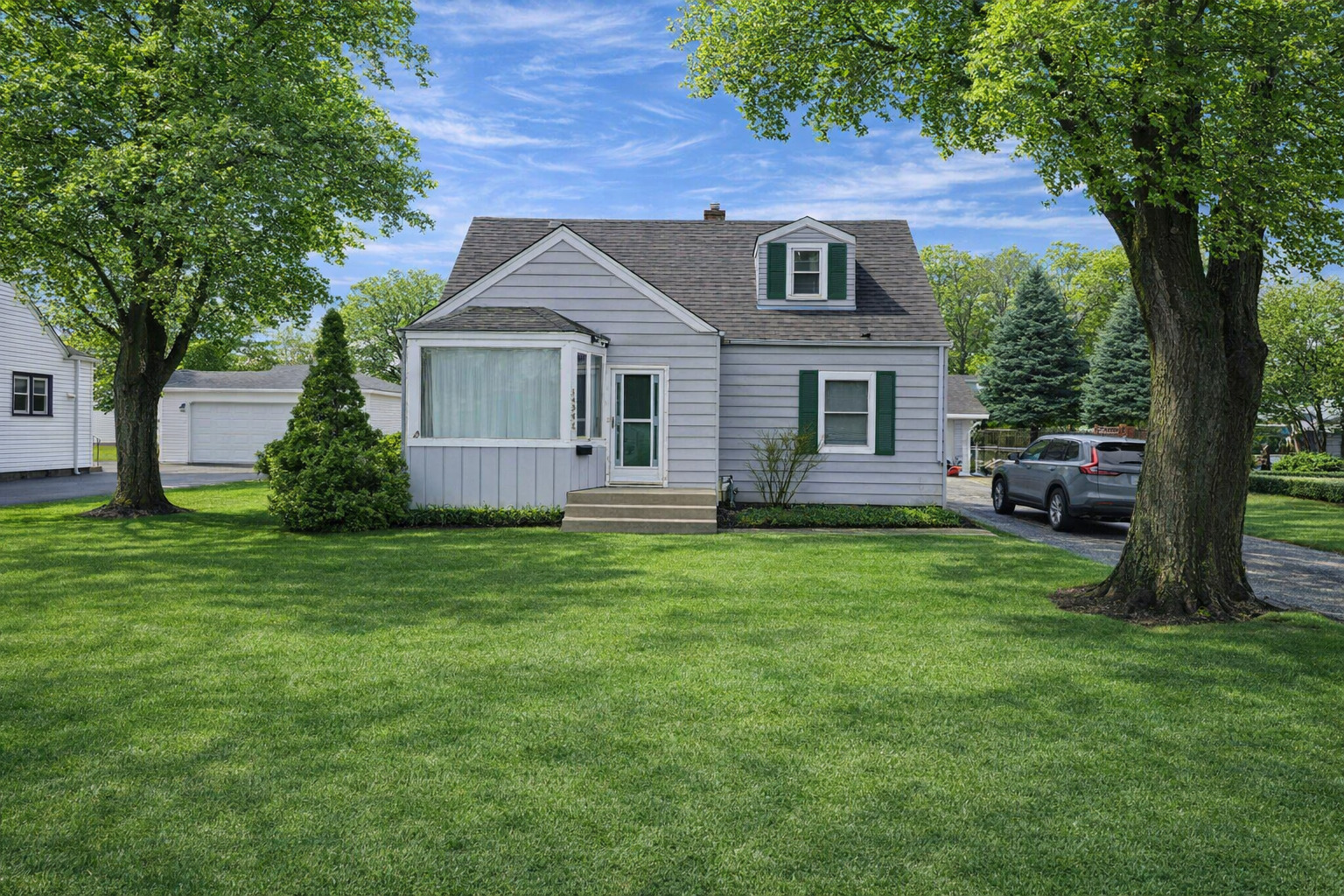 14348 Kolmar Avenue Midlothian, IL 60445 - Photo 1 of 13 a front view of house with yard and green space