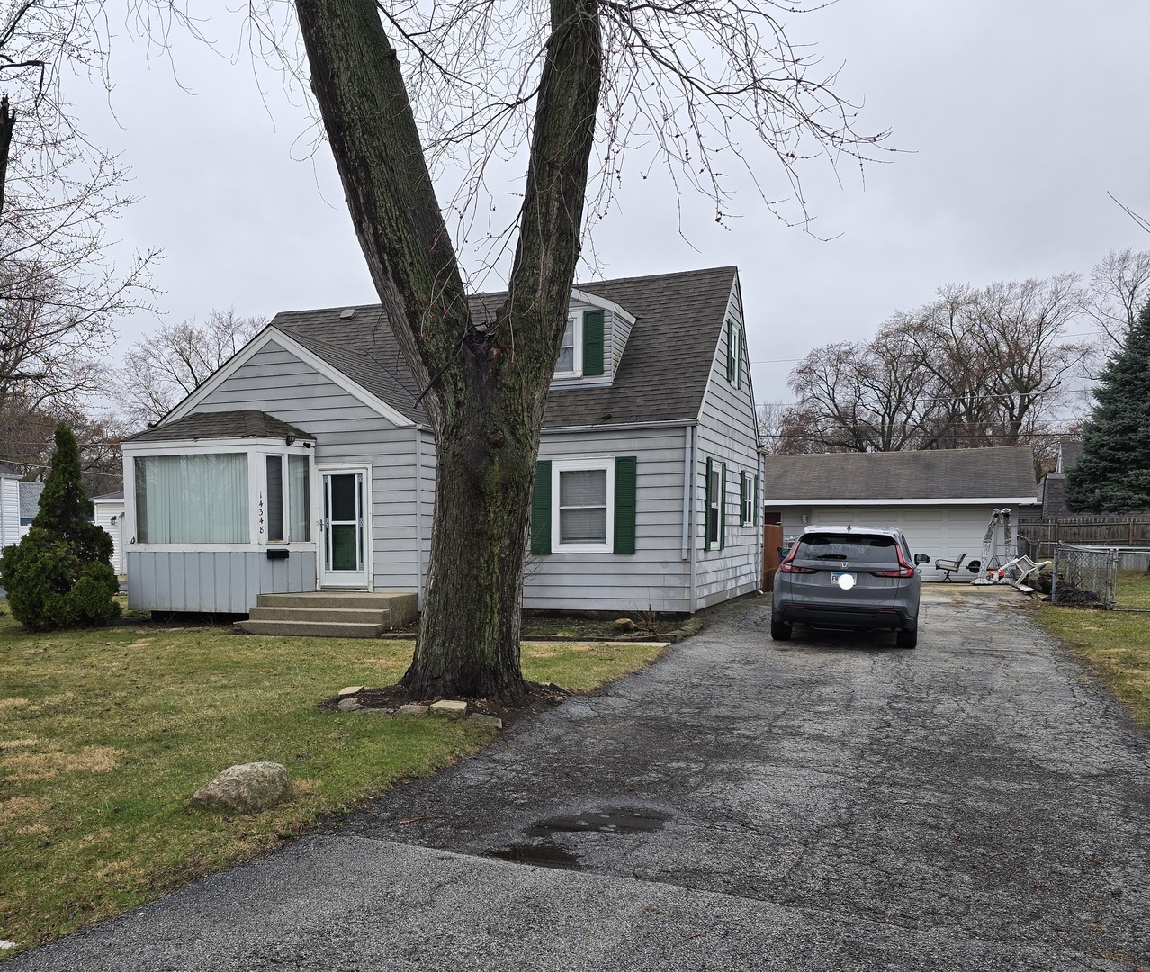 14348 Kolmar Avenue Midlothian, IL 60445 - Photo 2 of 13 a car parked in front of a house