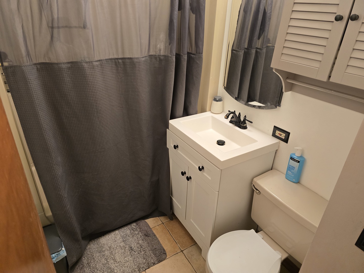 14348 Kolmar Avenue Midlothian, IL 60445 - Photo 9 of 13 a white toilet sitting next to a bathroom sink
