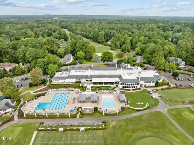 an aerial view of a house with a big yard