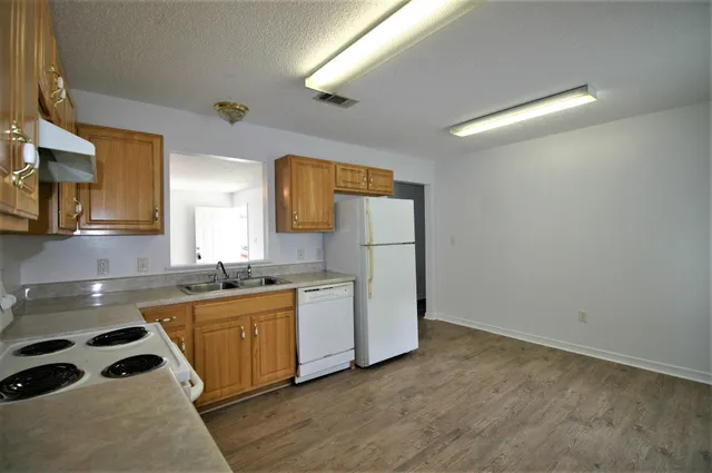 a kitchen with sink cabinets and stove