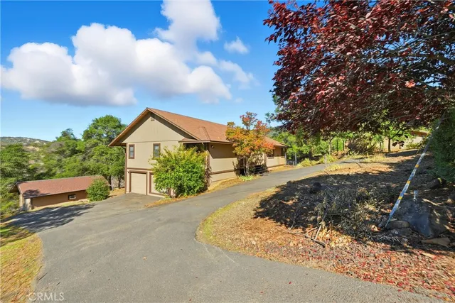 a view of a road with a house in the background