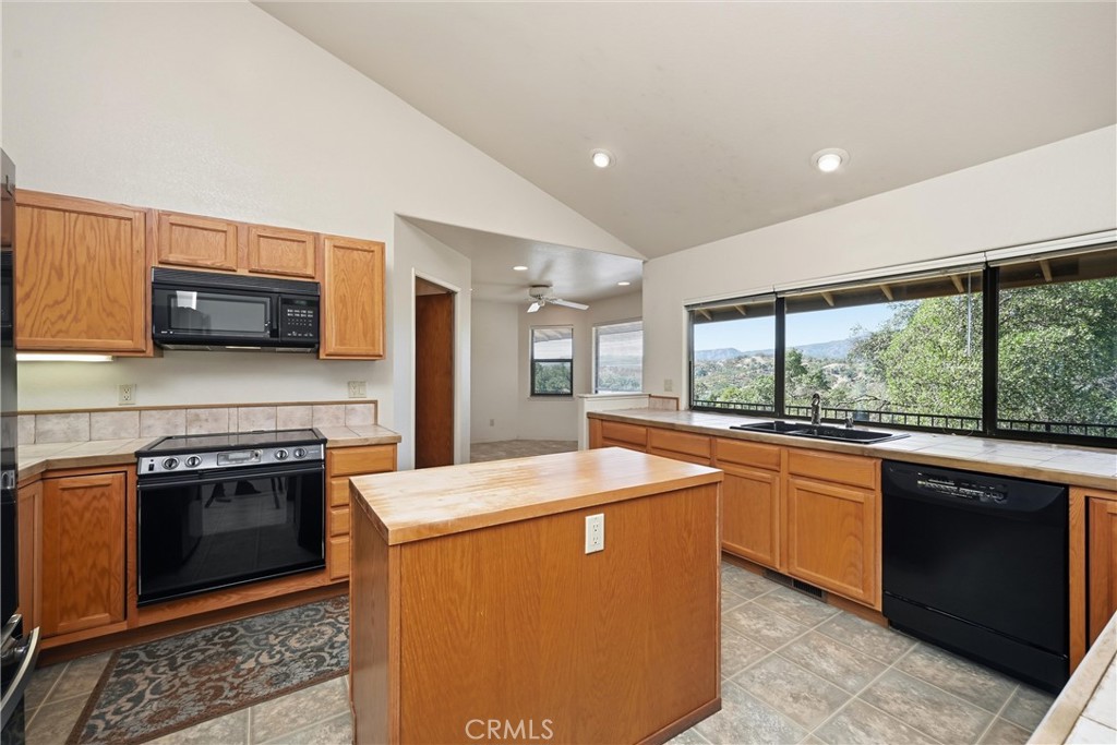 16261 Conestoga Road Hidden Valley Lake, CA 95467 - Photo 12 of 64 a kitchen with stainless steel appliances granite countertop a stove a sink and a microwave