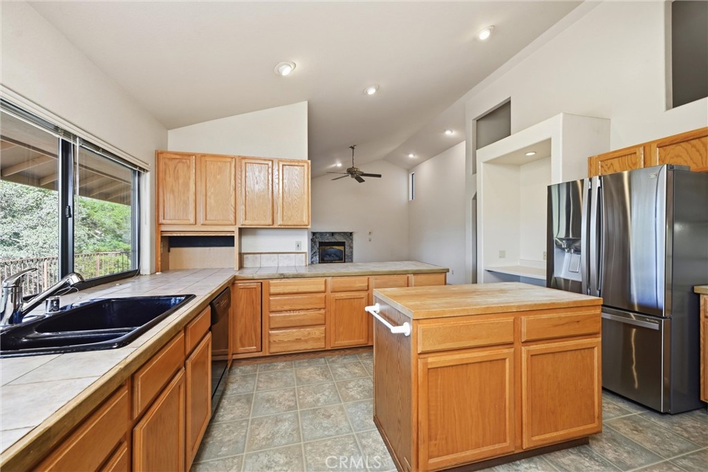 16261 Conestoga Road Hidden Valley Lake, CA 95467 - Photo 15 of 64 a kitchen that has a sink stainless steel appliances a window and a counter top space