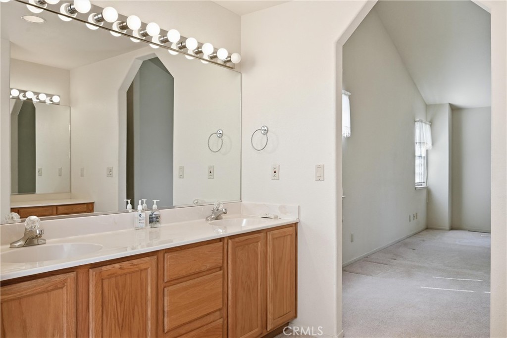 16261 Conestoga Road Hidden Valley Lake, CA 95467 - Photo 22 of 64 a bathroom with a double vanity sink and a mirror