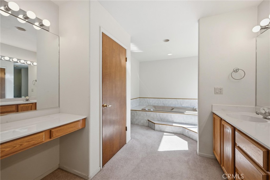 16261 Conestoga Road Hidden Valley Lake, CA 95467 - Photo 23 of 64 a bathroom with a tub sink and mirror