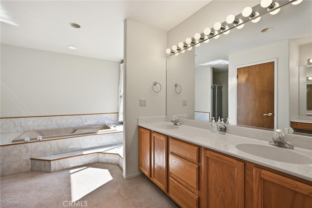 16261 Conestoga Road Hidden Valley Lake, CA 95467 - Photo 24 of 64 a spacious bathroom with a granite countertop sink a toilet a mirror and shower