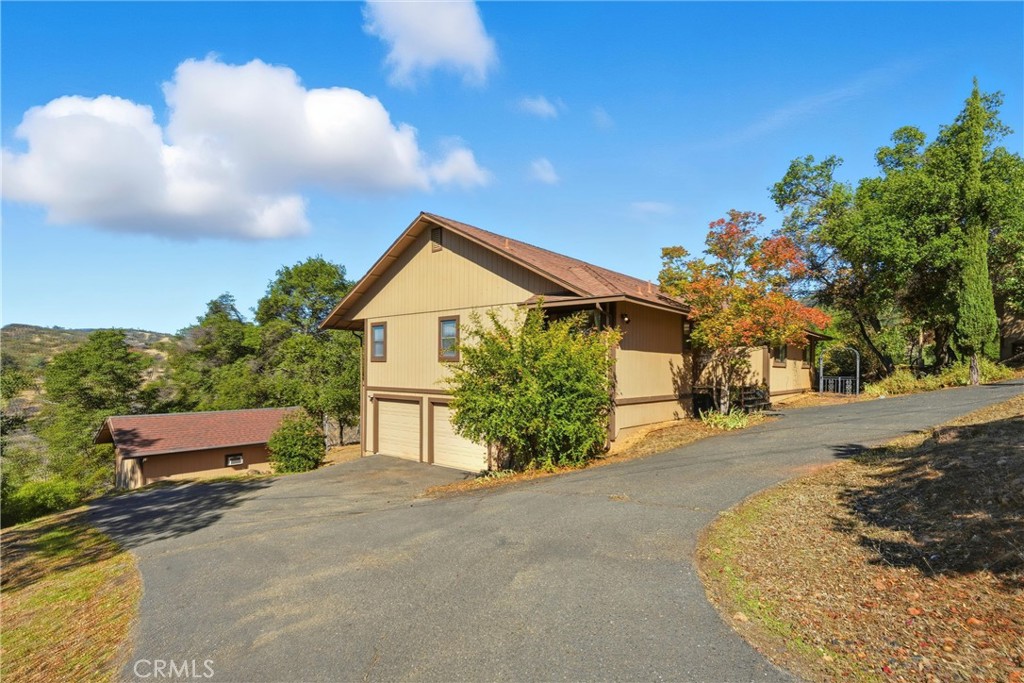 16261 Conestoga Road Hidden Valley Lake, CA 95467 - Photo 35 of 64 a front view of a house with a yard