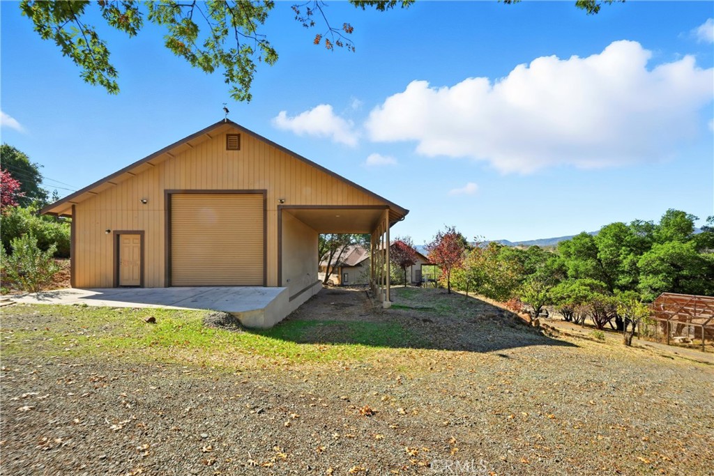 16261 Conestoga Road Hidden Valley Lake, CA 95467 - Photo 4 of 64 a front view of a house with a yard