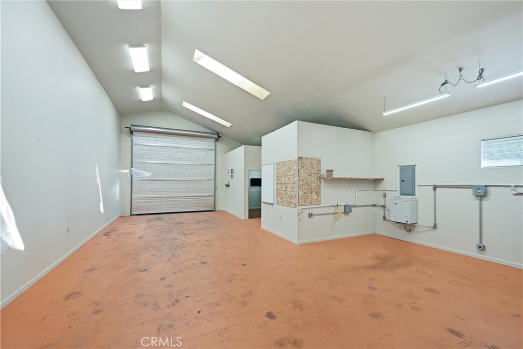 16261 Conestoga Road Hidden Valley Lake, CA 95467 - Photo 43 of 64 a large white kitchen with kitchen island a stove a sink and a refrigerator with white cabinets