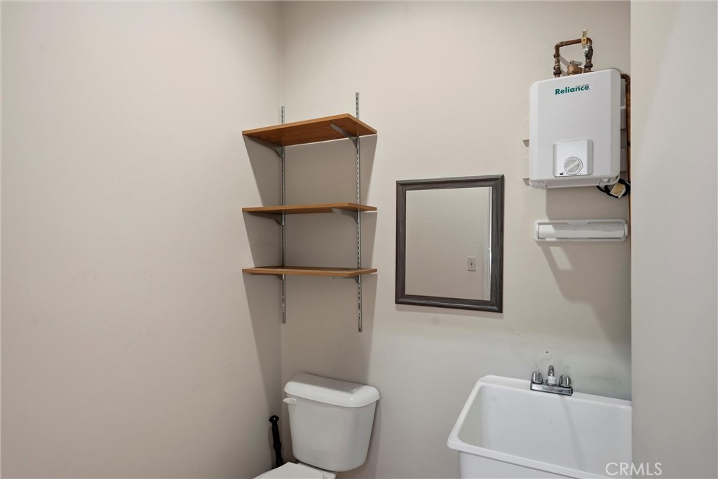 16261 Conestoga Road Hidden Valley Lake, CA 95467 - Photo 47 of 64 a bathroom with a toilet sink and mirror
