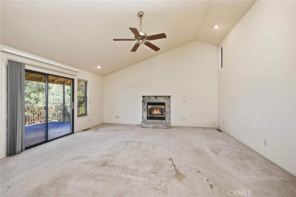 16261 Conestoga Road Hidden Valley Lake, CA 95467 - Photo 9 of 64 an empty room with windows and ceiling fan view