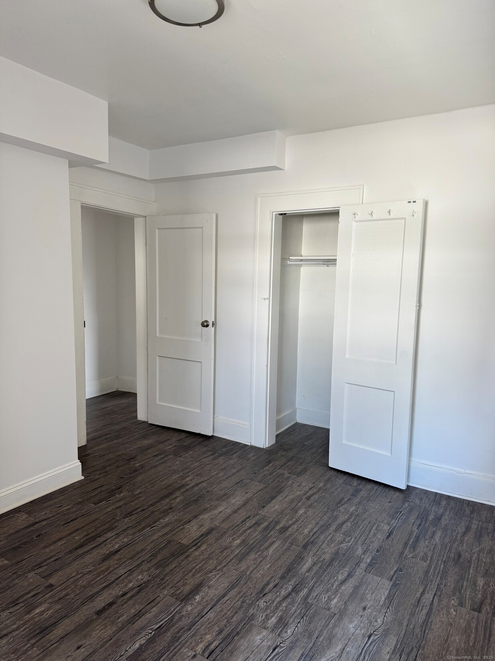 3142 Fairfield Avenue, Unit 2 Bridgeport, CT 06605 - Photo 9 of 11 a view of an empty room with wooden floor