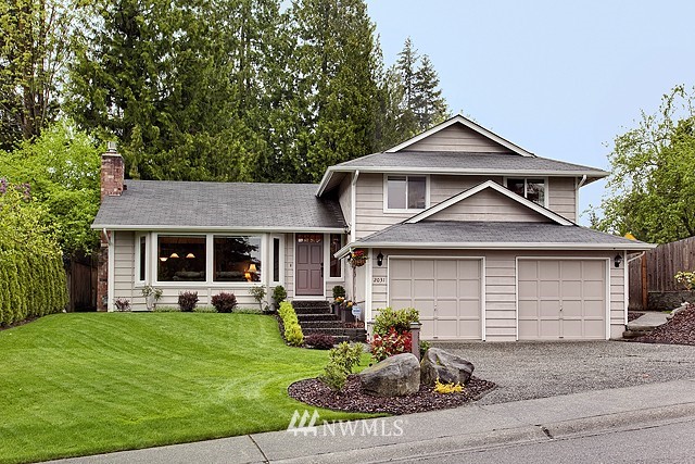 a front view of a house with a yard and garage