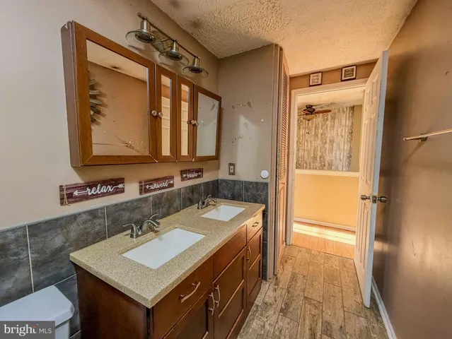 a bathroom with a sink a mirror and a bathtub