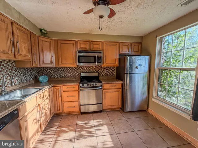 a kitchen with a refrigerator and a sink