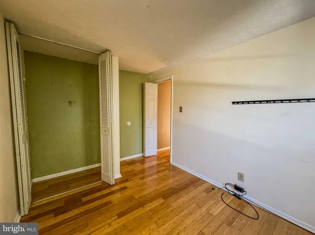 a view of a room with wooden floor