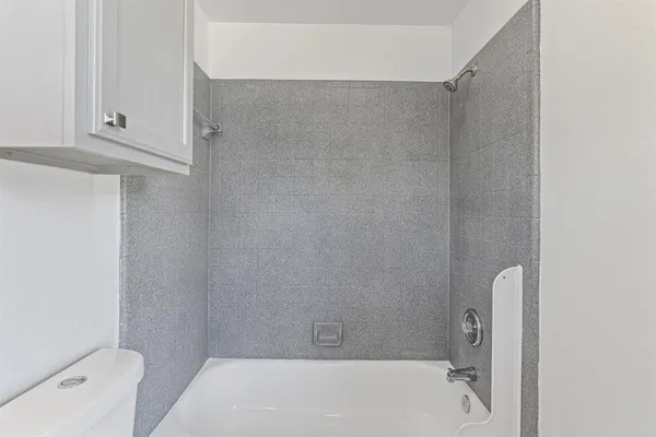 a bathroom with a bathtub and shower