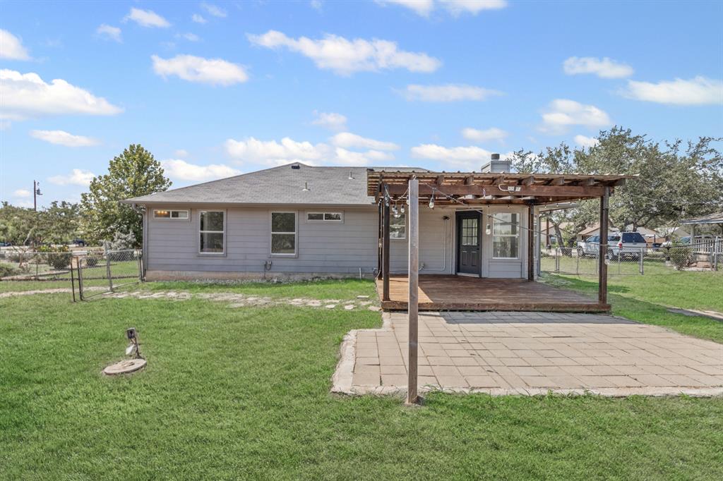 207 Panther Path Liberty Hill, TX 78642 - Photo 18 of 19 a front view of a house with a garden