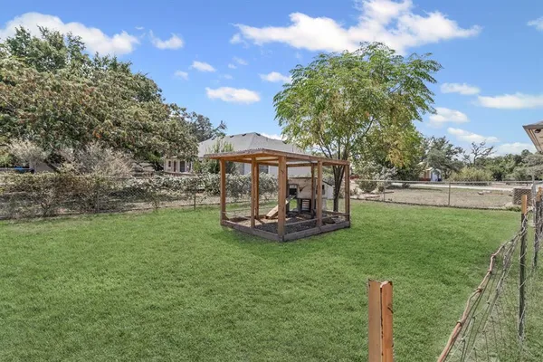 a view of a house with backyard and sitting area