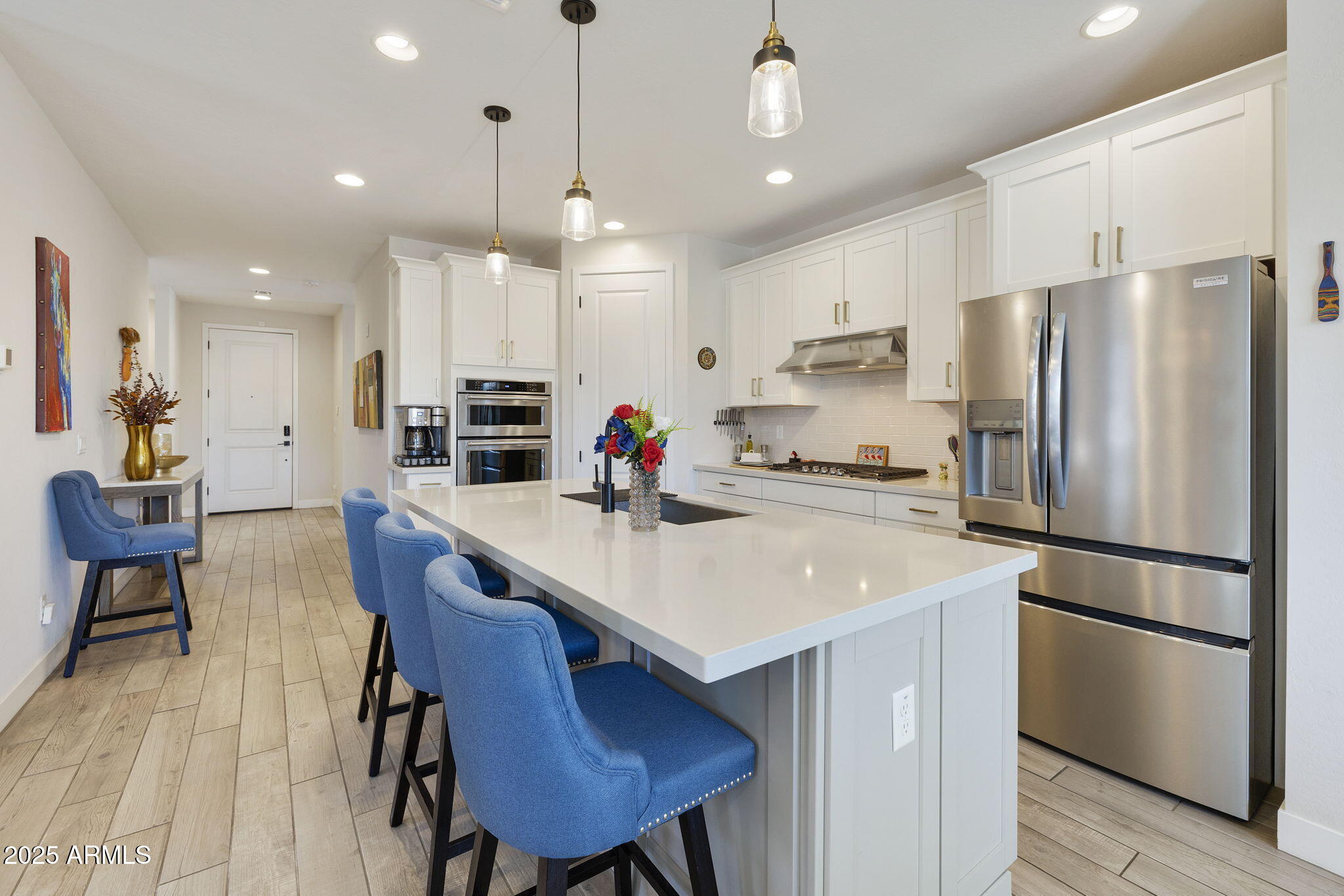 4557 South Element Mesa, AZ 85212 - Photo 24 of 34 a kitchen with stainless steel appliances a table chairs refrigerator and microwave