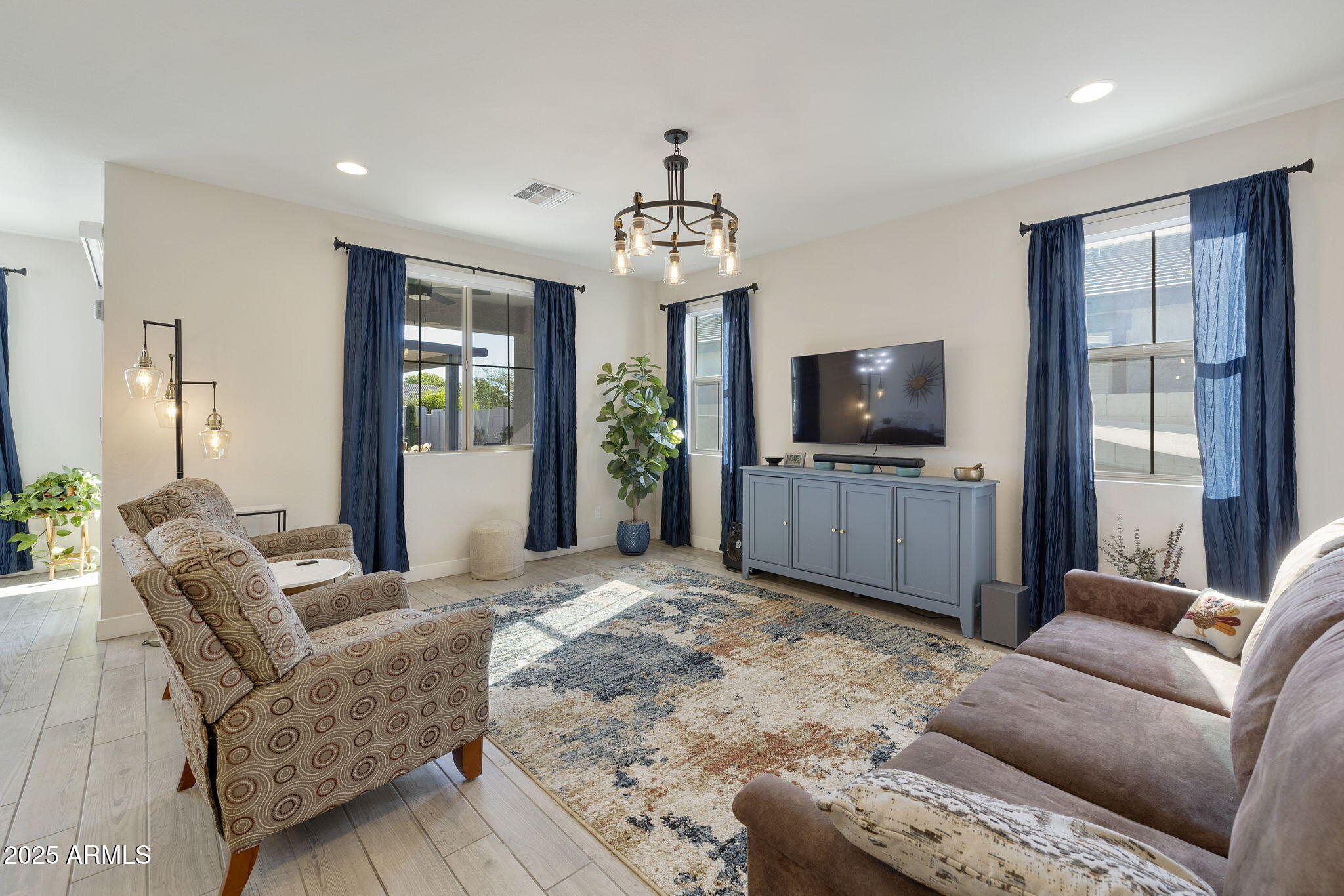 4557 South Element Mesa, AZ 85212 - Photo 5 of 34 a living room with furniture and a flat screen tv