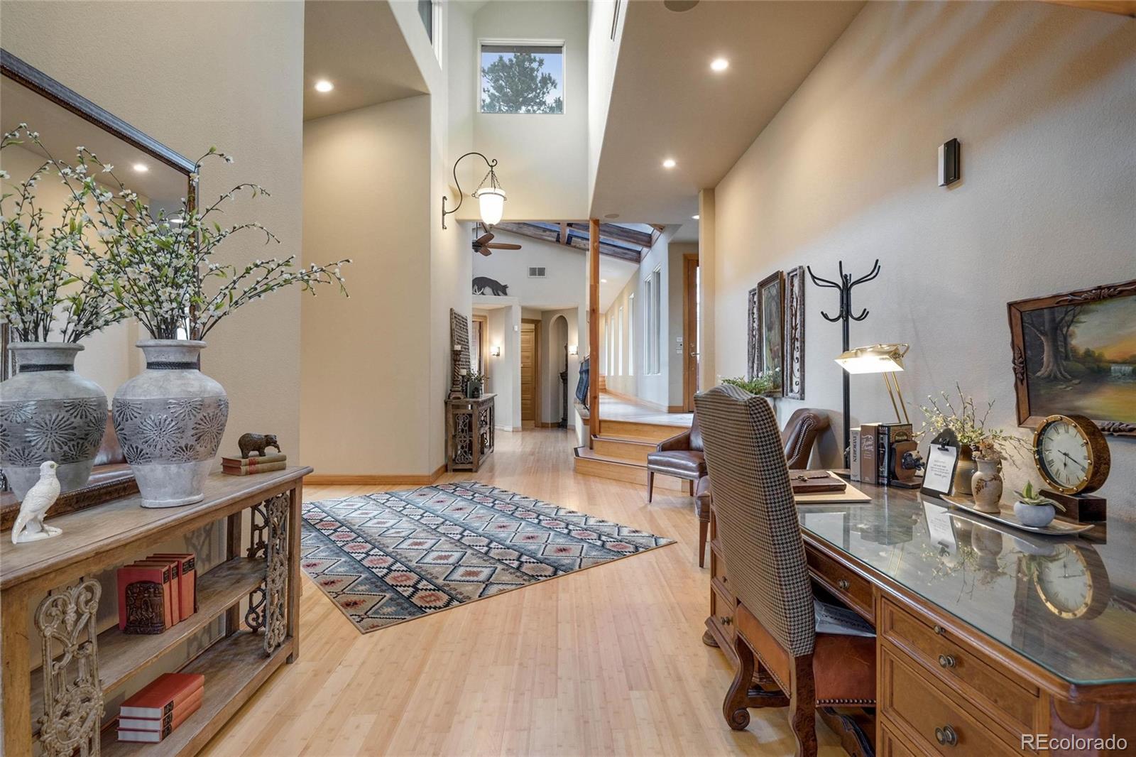 25580 Sunset Lane Evergreen, CO 80439 - Photo 13 of 40 a living room with stainless steel appliances furniture a rug and a flat screen tv