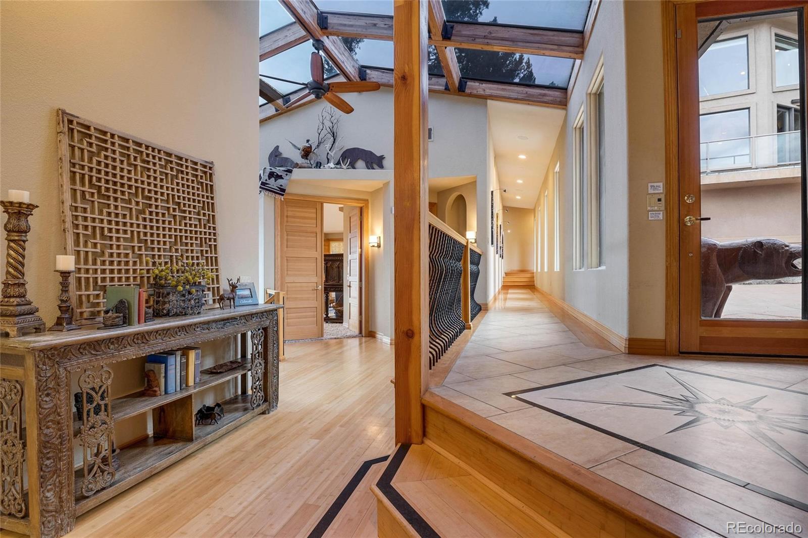 25580 Sunset Lane Evergreen, CO 80439 - Photo 14 of 40 a view of a balcony with wooden floor and furniture