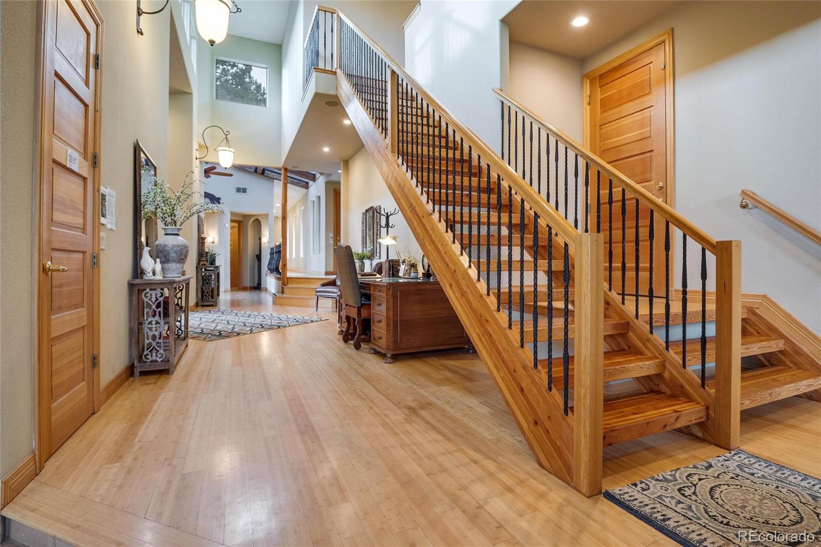 25580 Sunset Lane Evergreen, CO 80439 - Photo 15 of 40 a view of entryway and hall with wooden floor