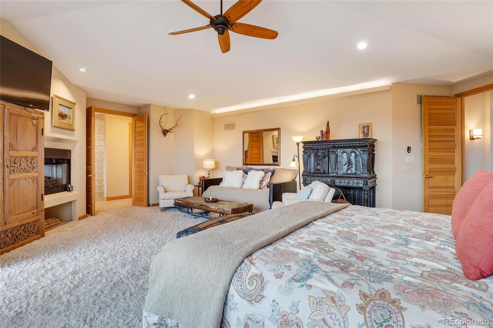 25580 Sunset Lane Evergreen, CO 80439 - Photo 16 of 40 a bed room with a bed and a television