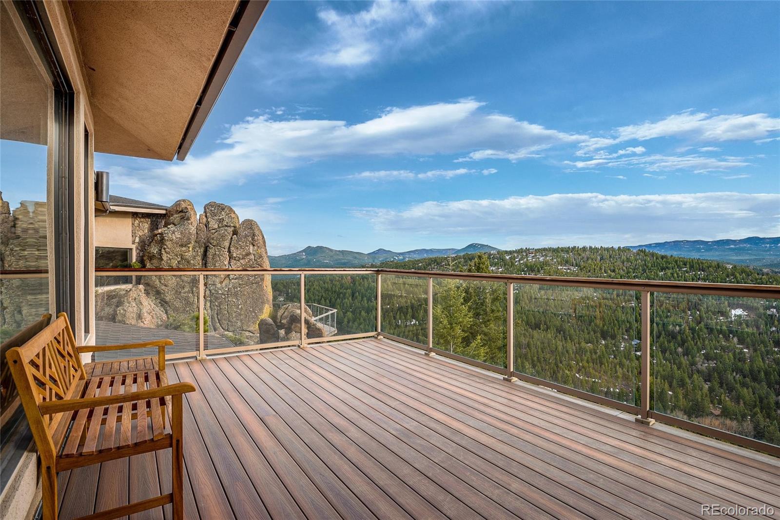25580 Sunset Lane Evergreen, CO 80439 - Photo 18 of 40 a view of a balcony with wooden floor and fence