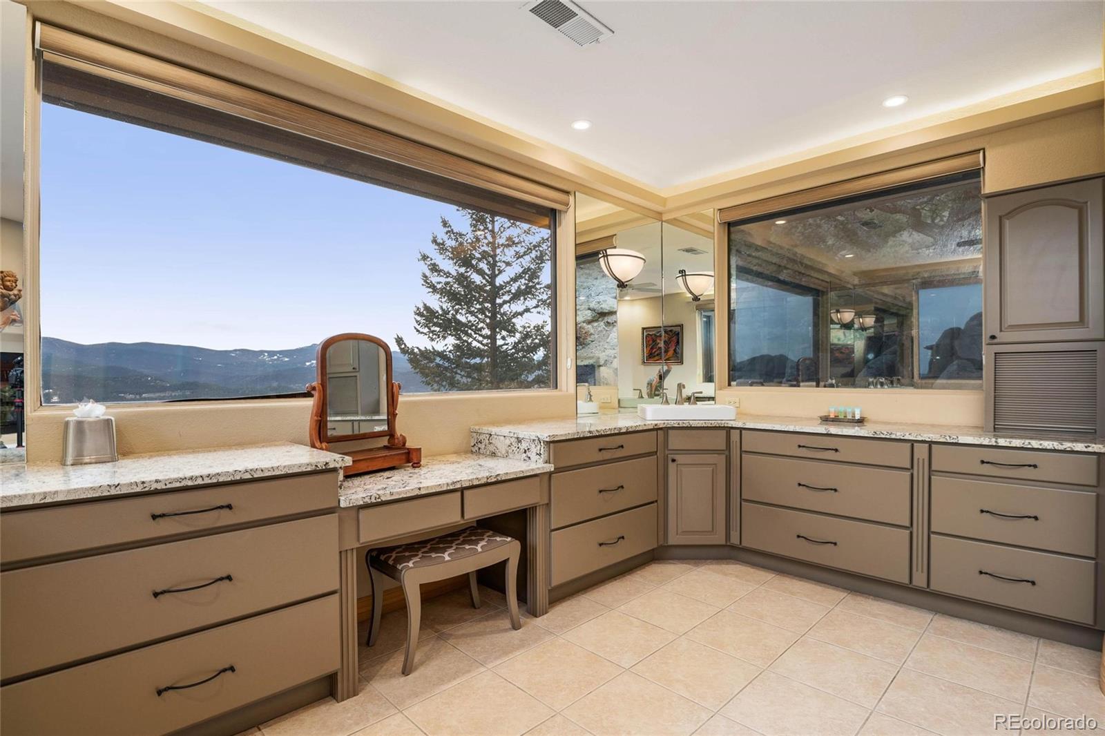 25580 Sunset Lane Evergreen, CO 80439 - Photo 20 of 40 a spacious bathroom with a granite countertop sink and a window