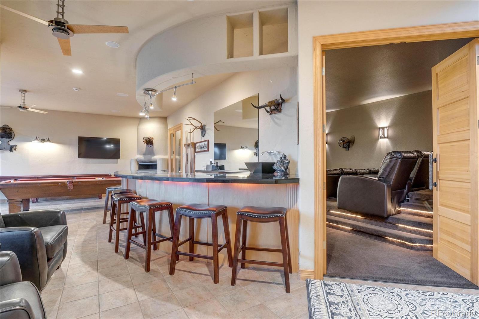 25580 Sunset Lane Evergreen, CO 80439 - Photo 31 of 40 a dining hall with stainless steel appliances kitchen island granite countertop furniture and a view of kitchen