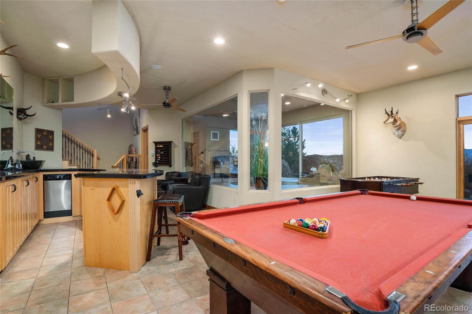 25580 Sunset Lane Evergreen, CO 80439 - Photo 32 of 40 a room with table chairs and kitchen view