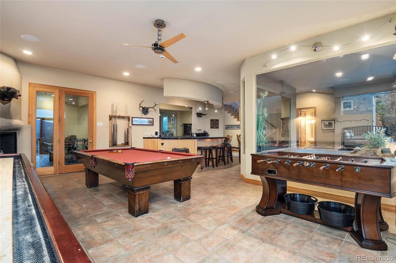 25580 Sunset Lane Evergreen, CO 80439 - Photo 33 of 40 a living room with furniture a table and kitchen view