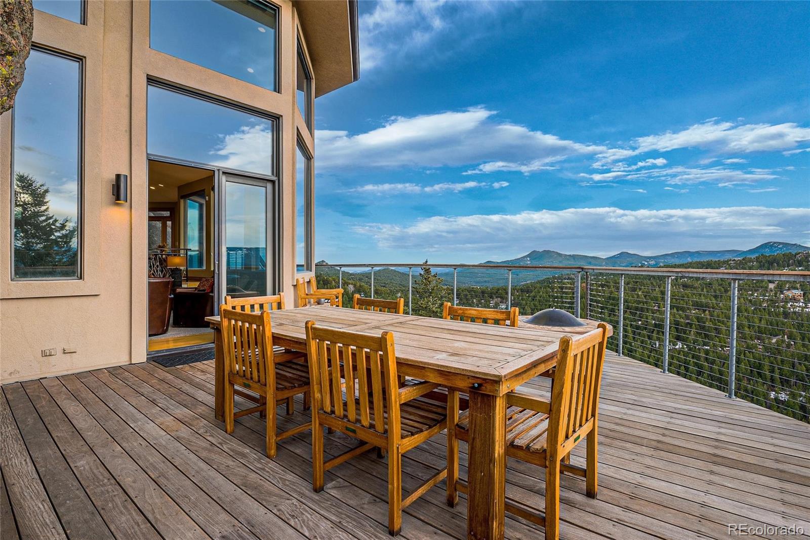 25580 Sunset Lane Evergreen, CO 80439 - Photo 10 of 40 a view of a dinning table and chairs on roof deck