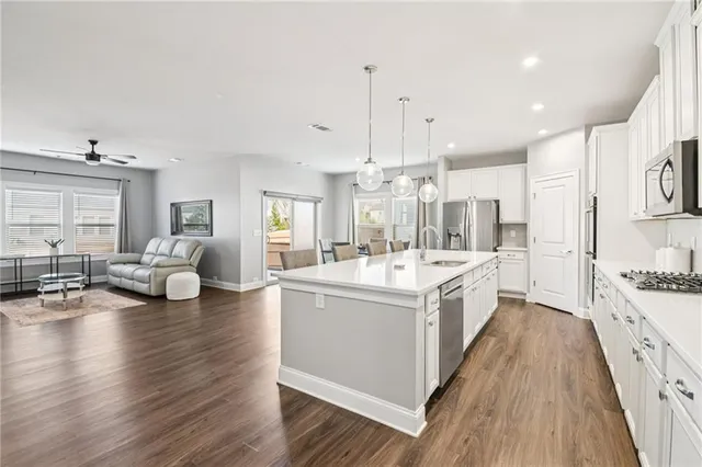 an empty room with closet and a ceiling fan