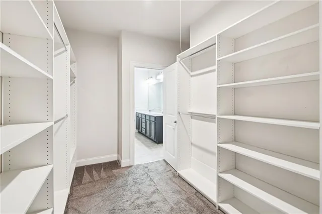 a spacious bathroom with a double vanity sink a mirror and a shower