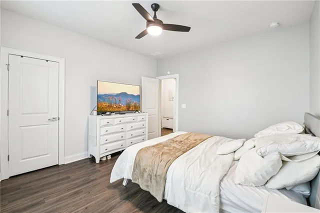 a view of a white house next to a yard