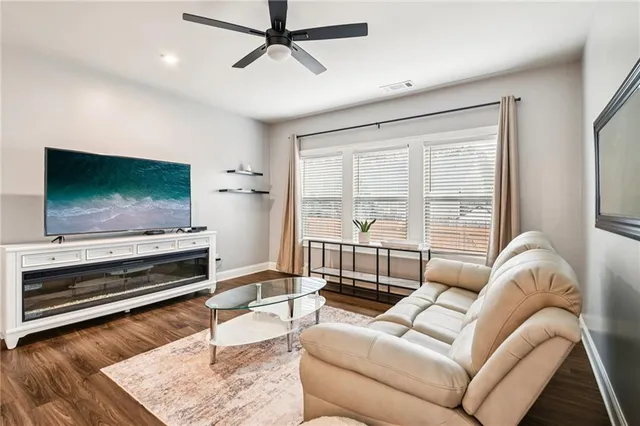a living room with furniture and wooden floor