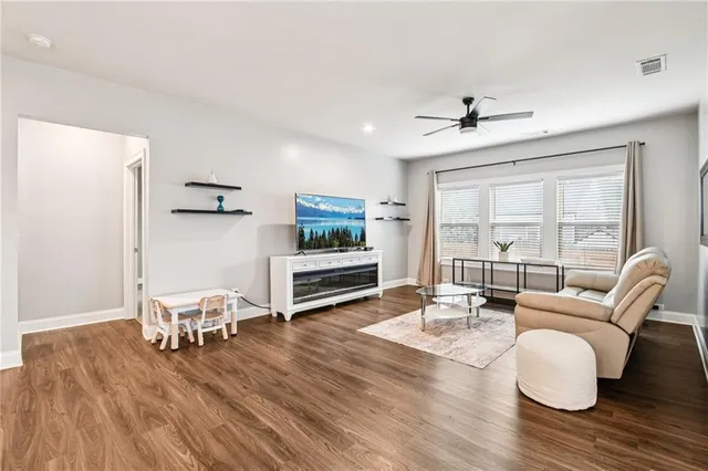 a living room with furniture and wooden floor