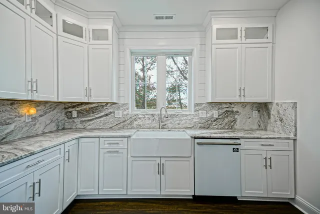 an empty room with wooden floor and a ceiling fan
