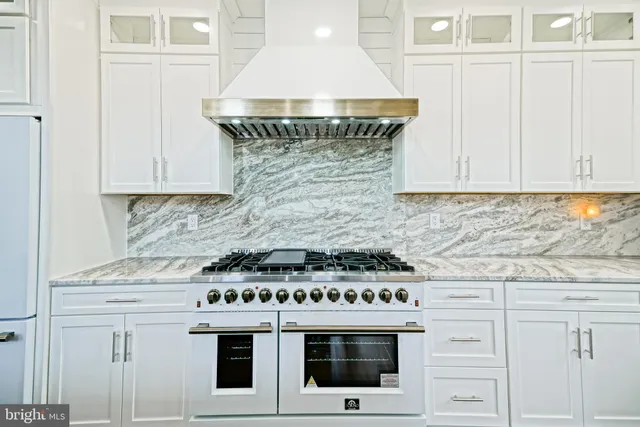 a view of walk in closet with wooden floor
